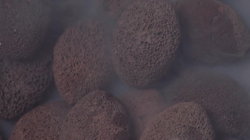 Fossilized rocks in a pile with fog or mist rolling throughout the rocks