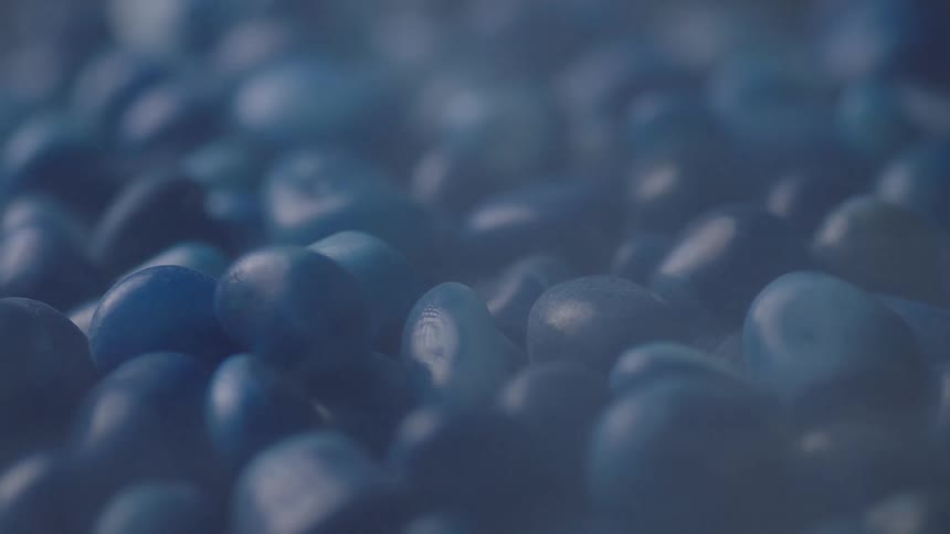 A large pile of grapesized bluecolored rocks is shown while the camera orbits around them