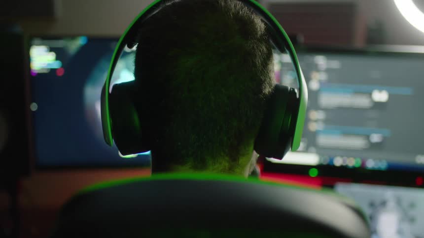 A man playing fortnite with the focus being on his head and headphones