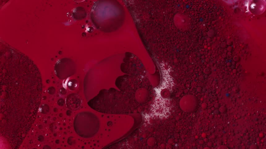 Red paint bubbled up and forming around in swirls