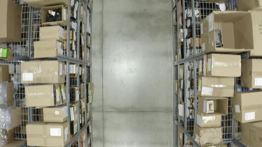 An aerial of a factory with boxes on the shelves and a concrete floor