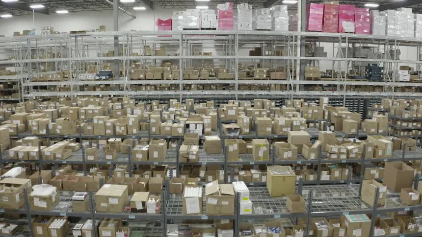 Giant warehouse of a store like ikea with hundreds of shelves of inventory in boxes and crates