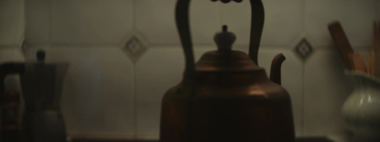 A person pours a tea kettle