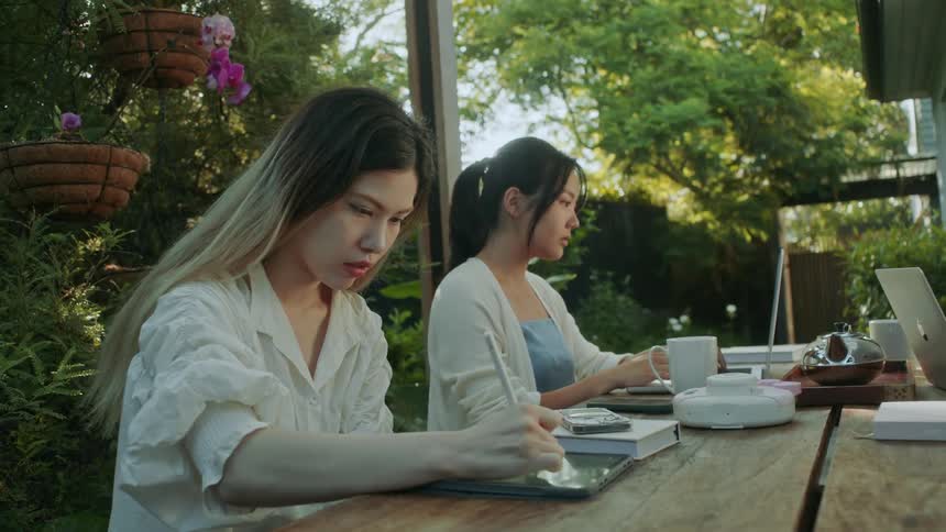 Two friends are outdoors and hanging out outdoors