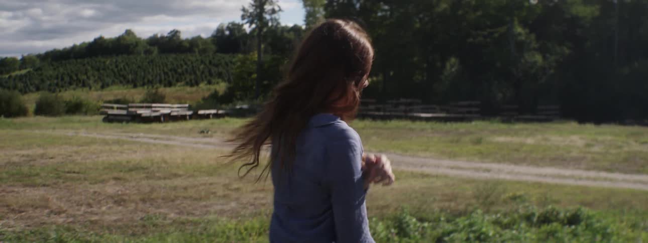 A woman is dancing in a field