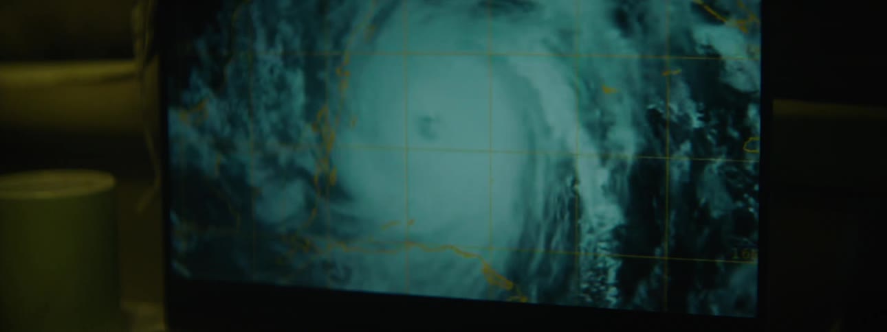 Close up of the screen of a television displaying satellite weather imagery of a hurricane