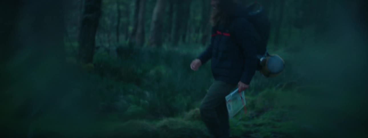 A man hiking through a foggy forest