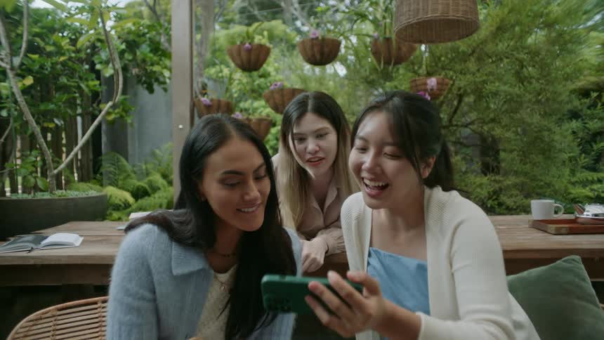 Friends are outdoors and taking pictures on there phone