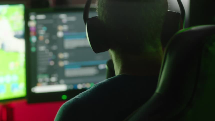 A man is playing video games on his computer
