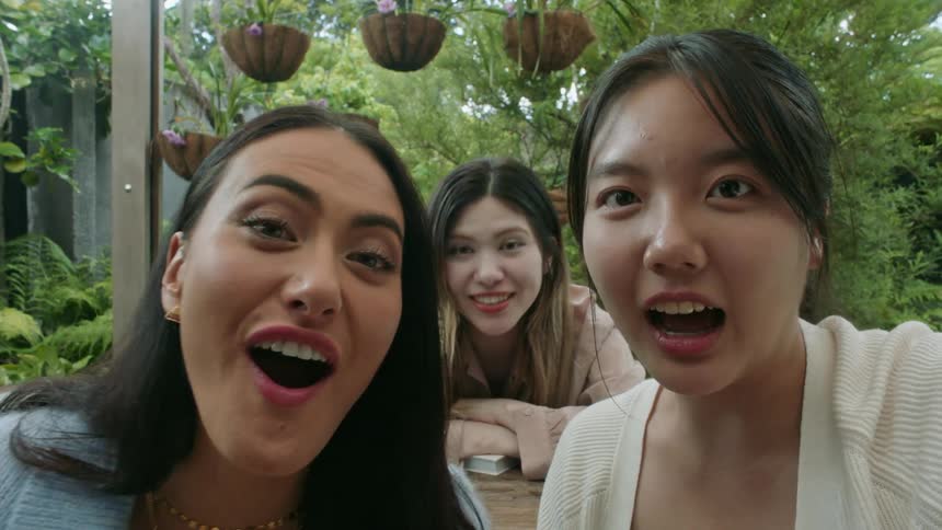 Women laugh and pose