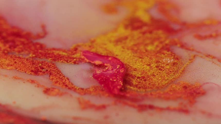 Red yellow and white liquid paint mixed together