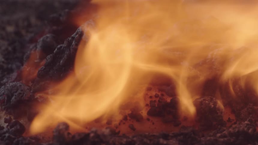 An up close of a flame burning a white substance