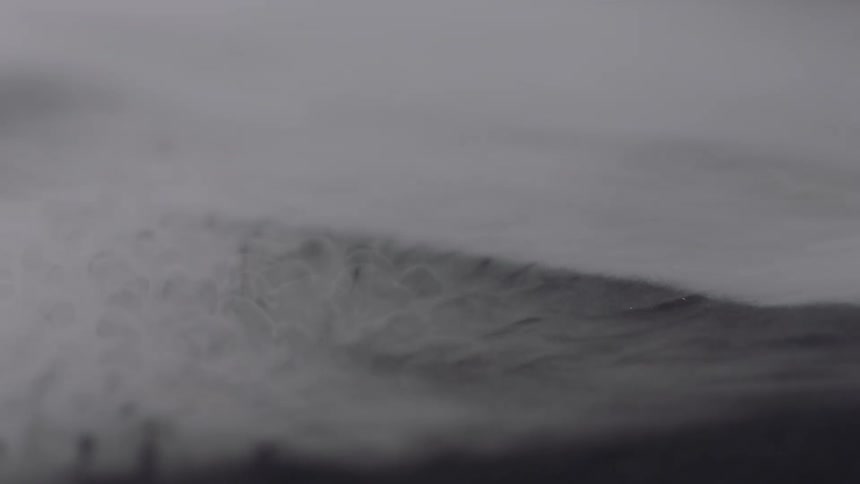 An up close of smoke rolling off grey material