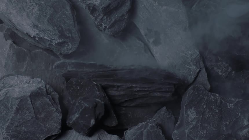 Rocks being dropped and broken on others creating dust