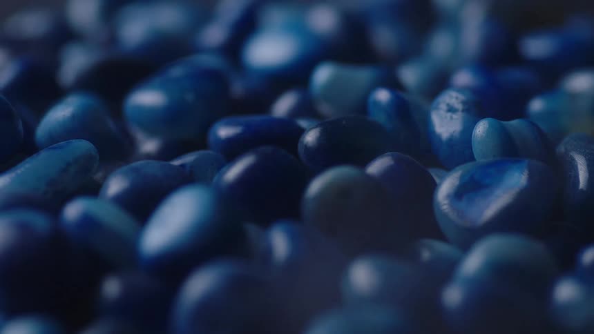 Orbiting close up of a bunch of blue pebbles