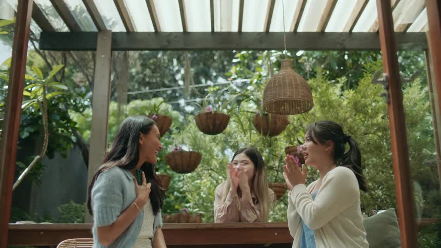 A group of friends are sitting on a balcony together