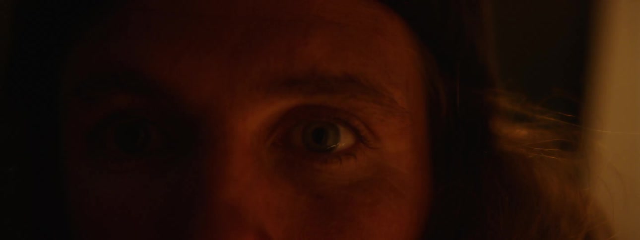 An extreme up close of a mans eye staring