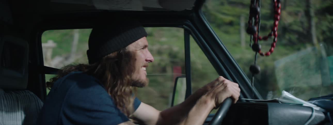 A man is driving his vehicle during the spring time
