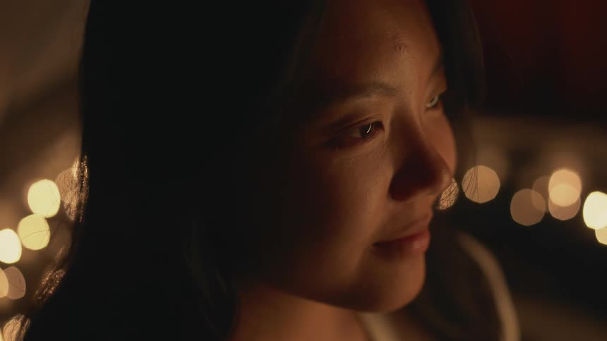 Close up view of a woman sitting inside of a tent