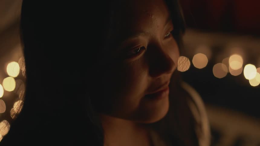 A close up of a womans face slightly smiling