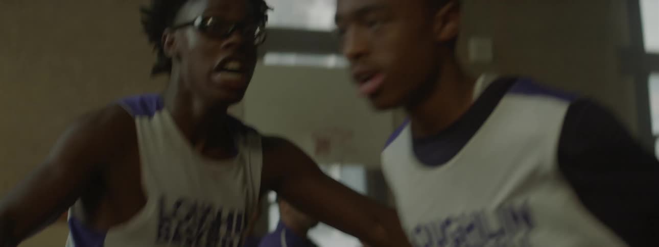 Basketball player trying to stop other players from fighting