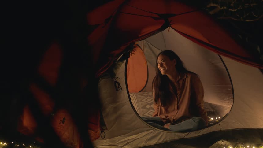 A woman sits in the tent