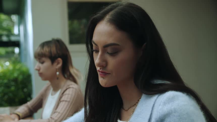 Two women are sitting in class