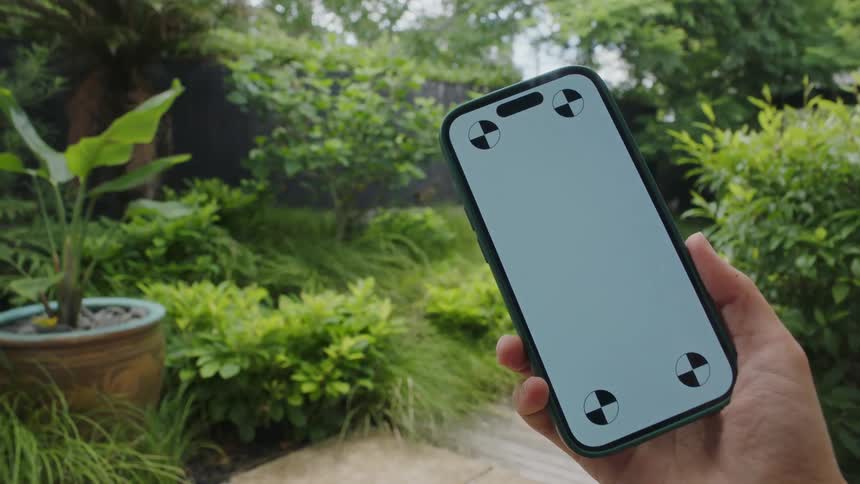 A male hand holds up a cell phone and shows it to the camera