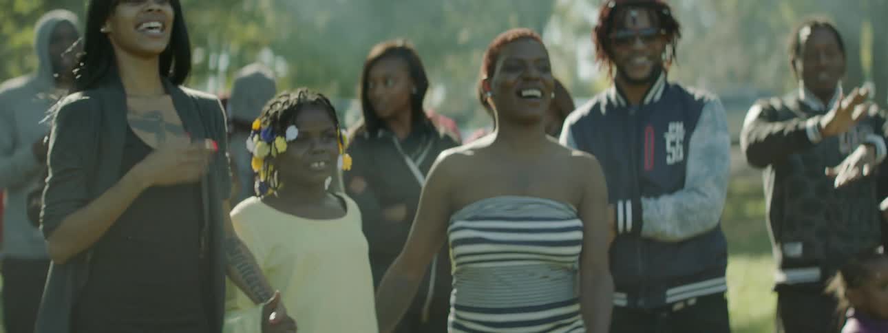 People are dancing and smiling on a sunny day
