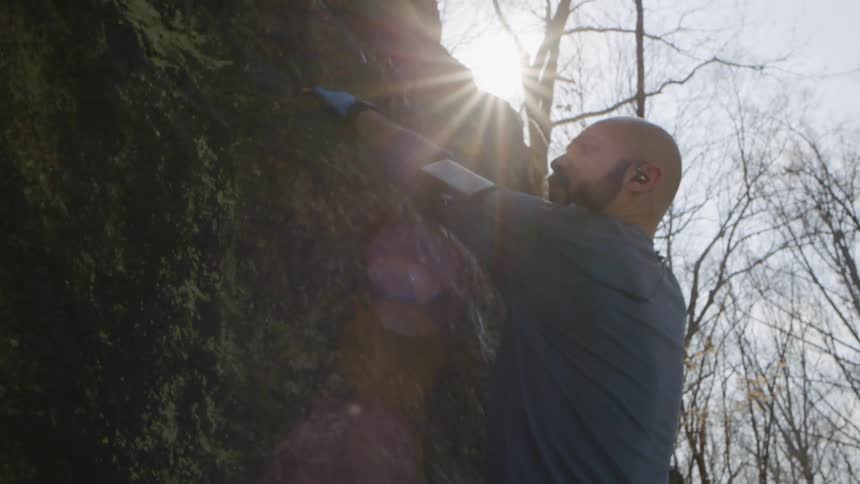 The man climbs up the rocks