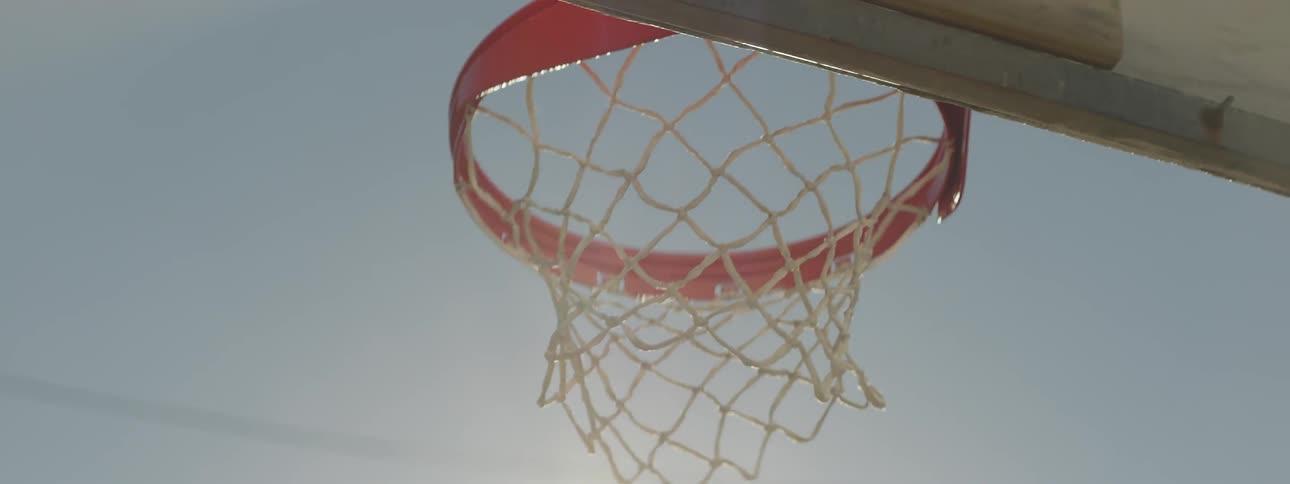 Close up of a basketball hitting a hoop