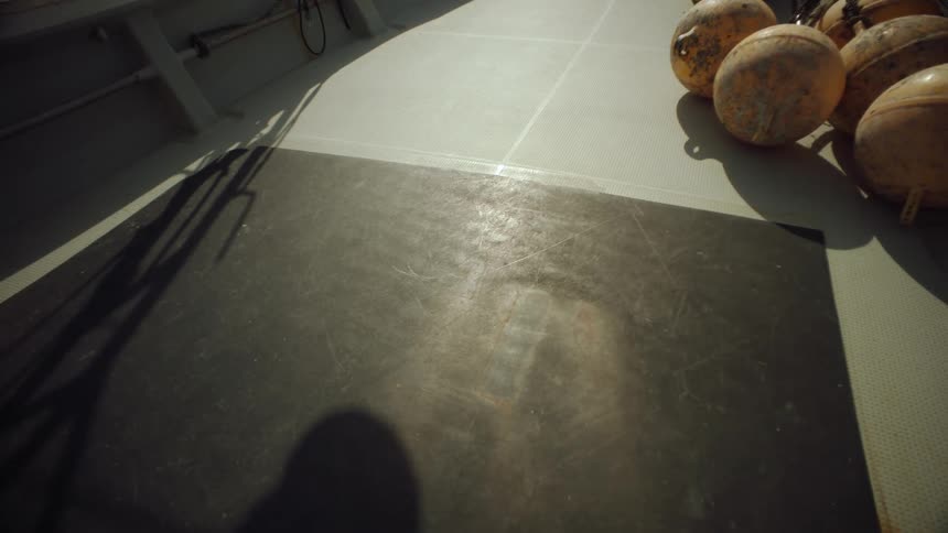 Shadow cast onto floor near cluster of spheres sways