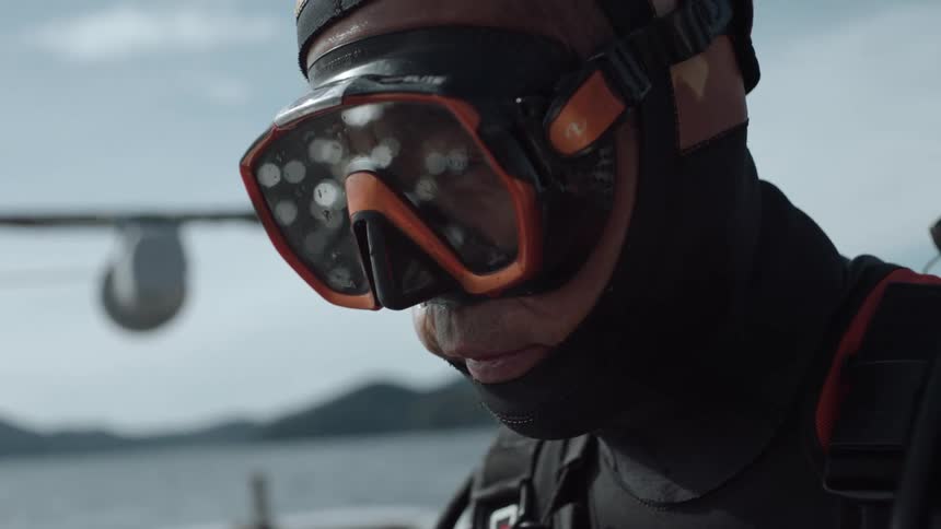 A man is wearing swimming goggles outdoors