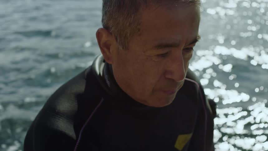 A man is swimming in the water and wearing swimming gear
