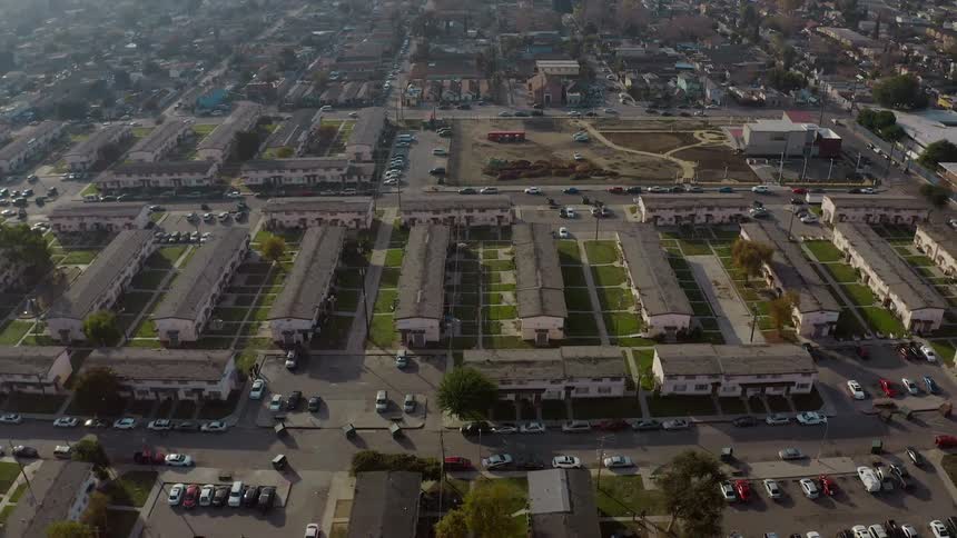 Cars are driving through a downtown city in spring