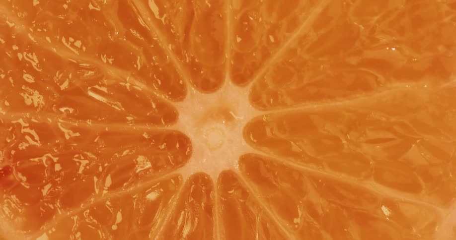 Close up view of the inside of an orange fruit is displayed