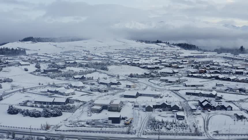 Aerial view of a suburban city during winter is displayed