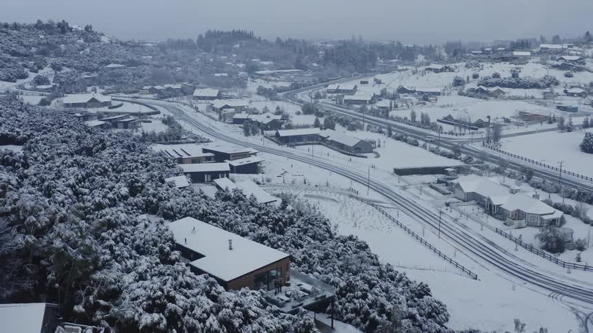 Aerial view of a suburban city during winter is displayed