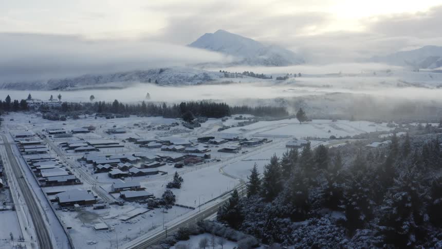 Aerial view of a suburban city during winter is displayed