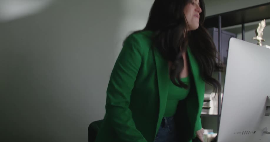 A woman is walking into her computer office
