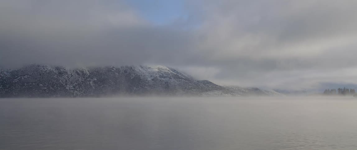Fog is covering the ocean water at midday