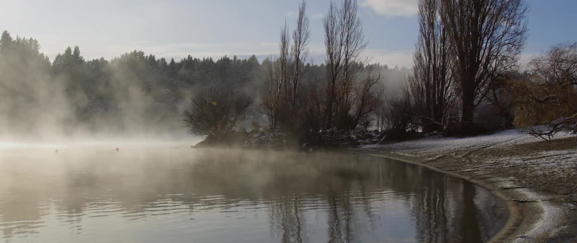 Mist is covering the body of water during winter