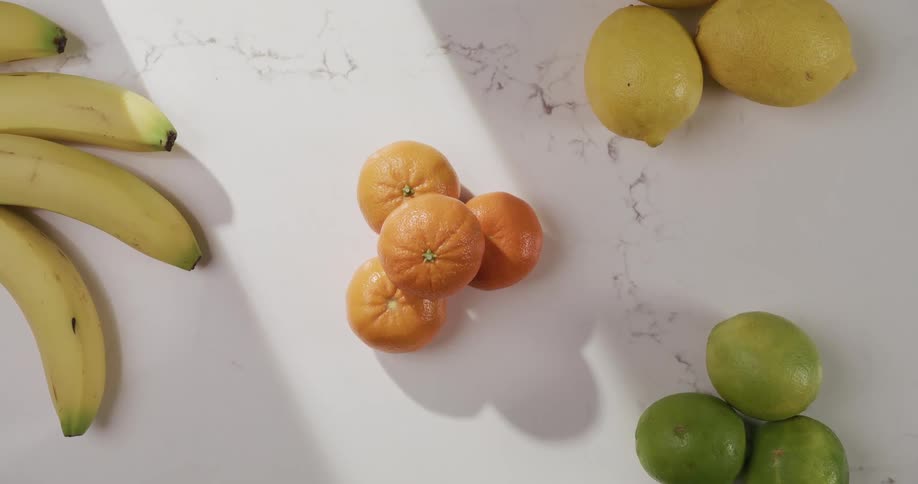 Four different types of fruit are displayed on the table