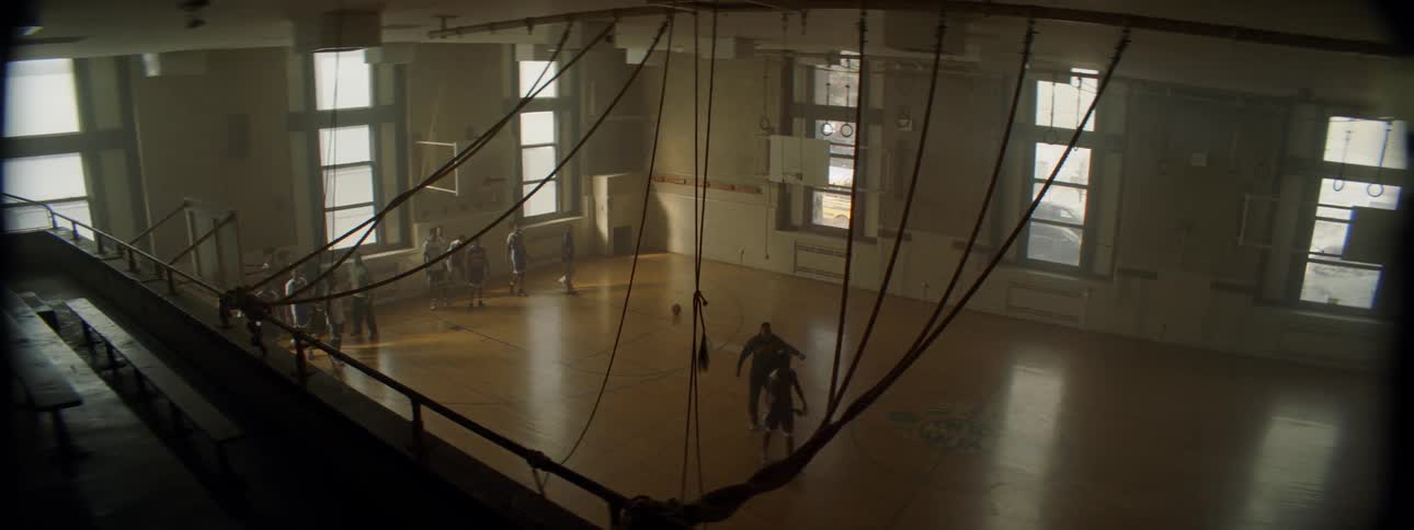 A group of kids playing basketball indoors