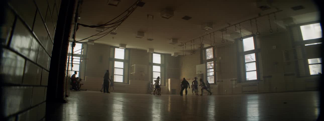People are playing basketball on a court