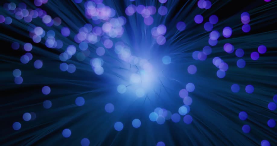 A bright light glows as rays turn among purple and pink changing orbs