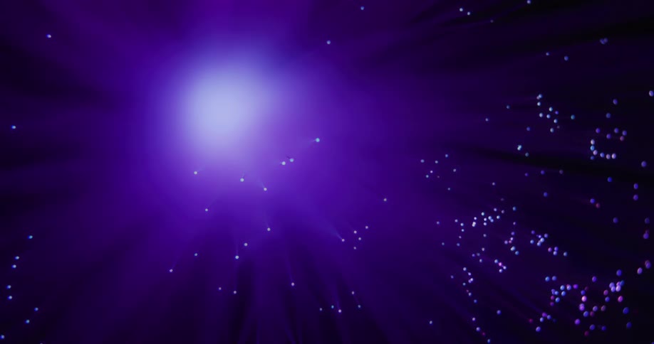 A purple galaxy with stars and flares coming from the center light