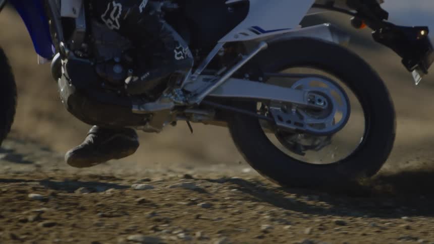 A person turns on their dirt bike