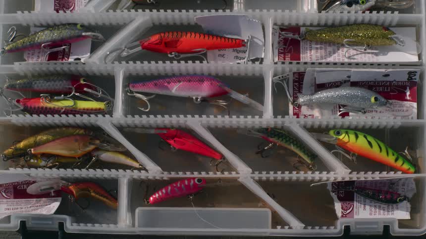Close up view of a fishing tackle box is displayed