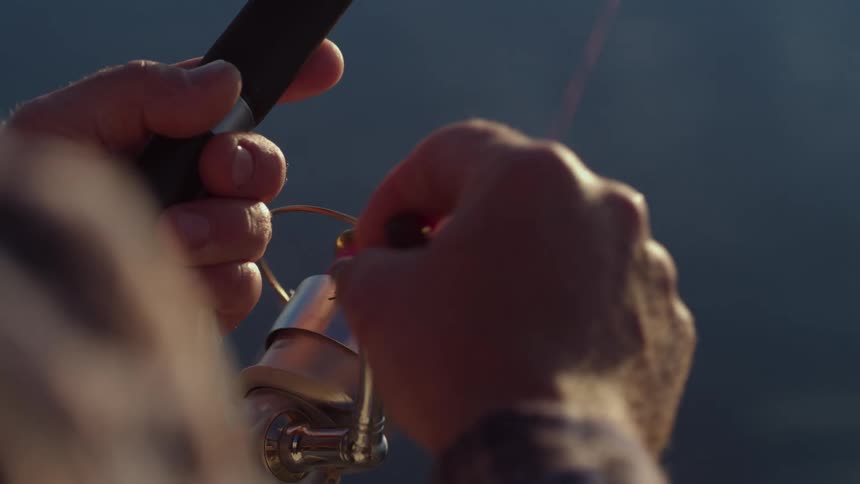 A man reels in his fishing rod